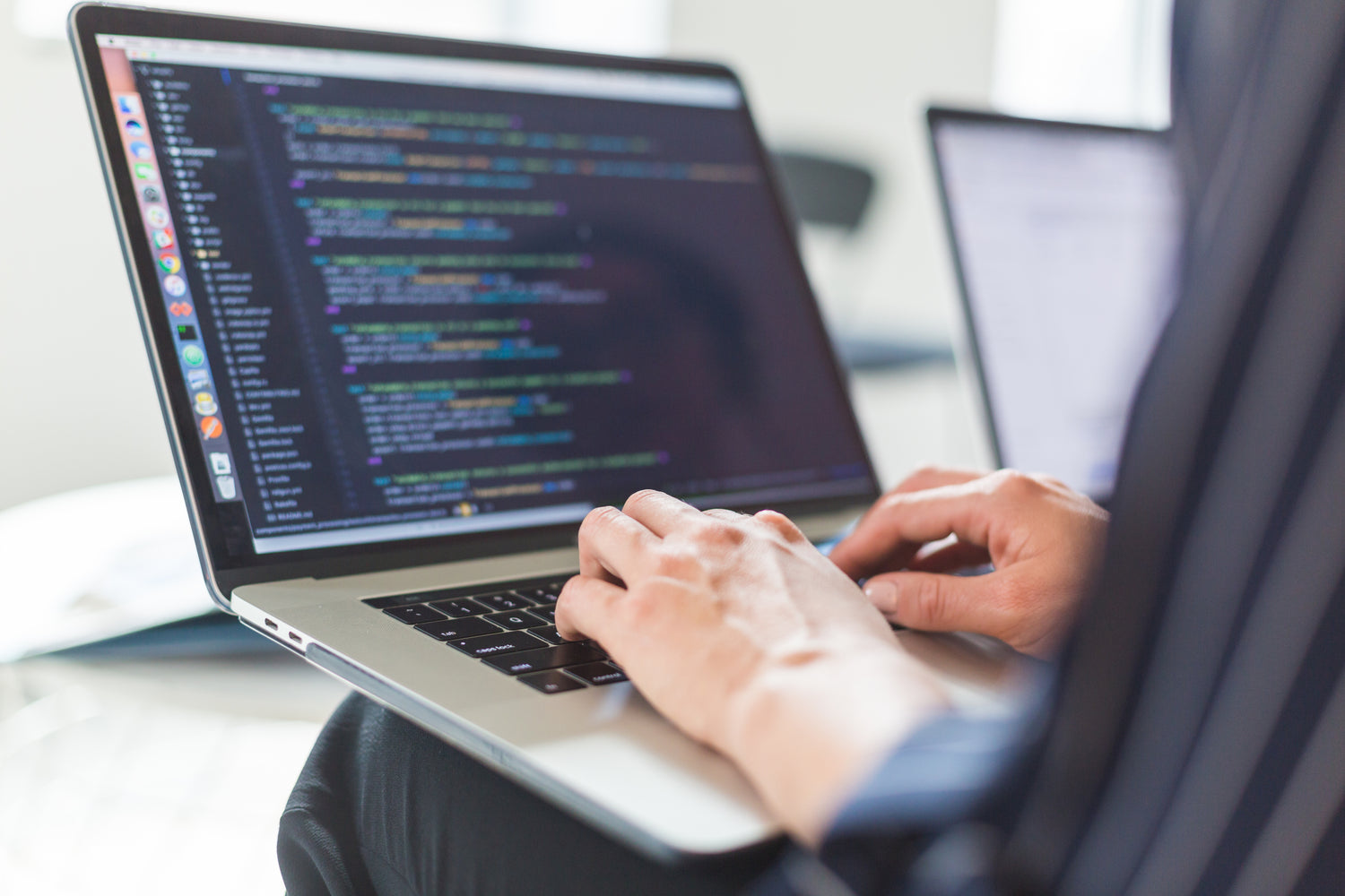 Man writing code on a computer